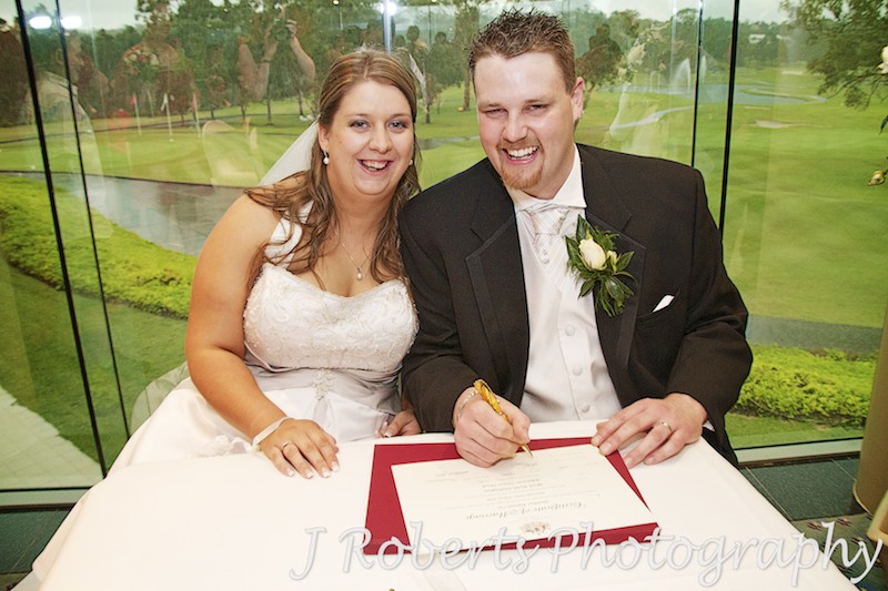 Bride and groom signing the register - wedding photography sydney